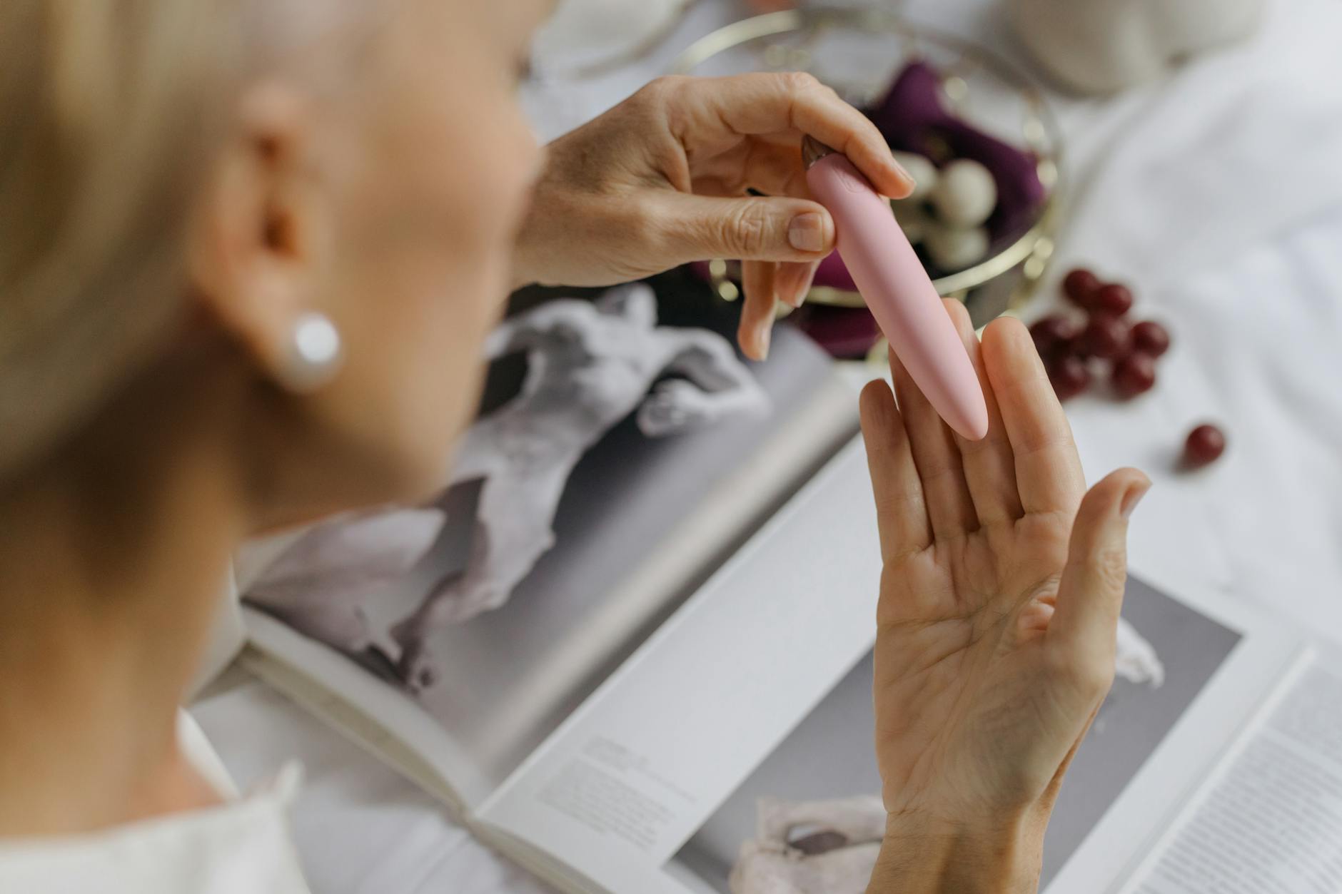 Close-up of hands holding a vibrator, emphasizing intimate pleasure and personal wellness.