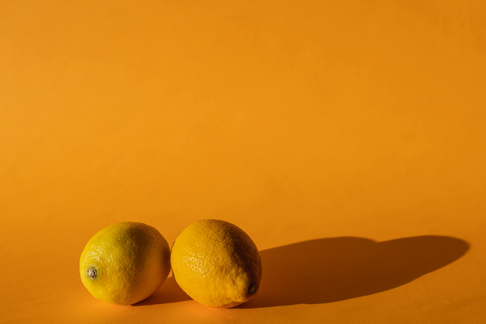 A hand displaying colorful sex toys including clitoral vibrators arranged on a surface